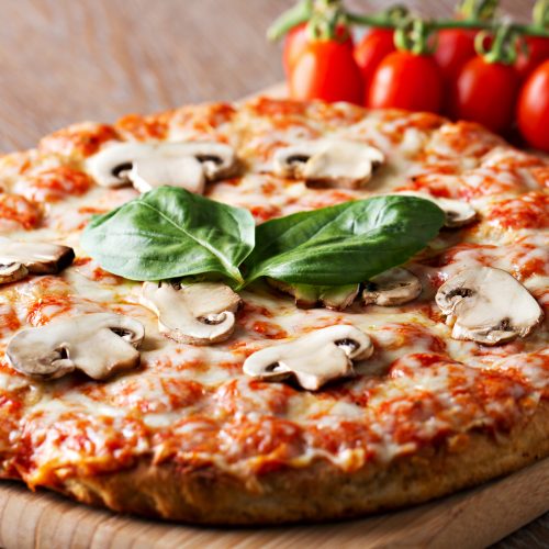 Pizza with mushrooms and basil